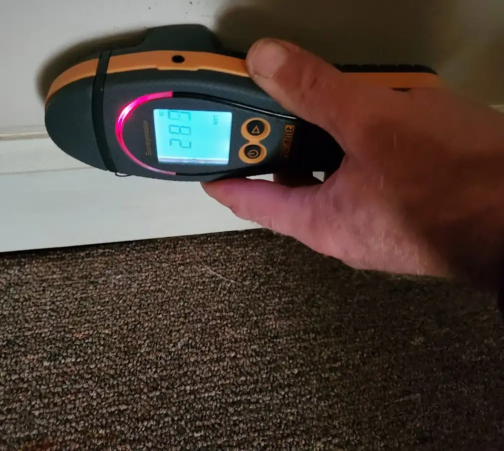 Moisture detection at baseboard during Storm Damage Restoration in Saco